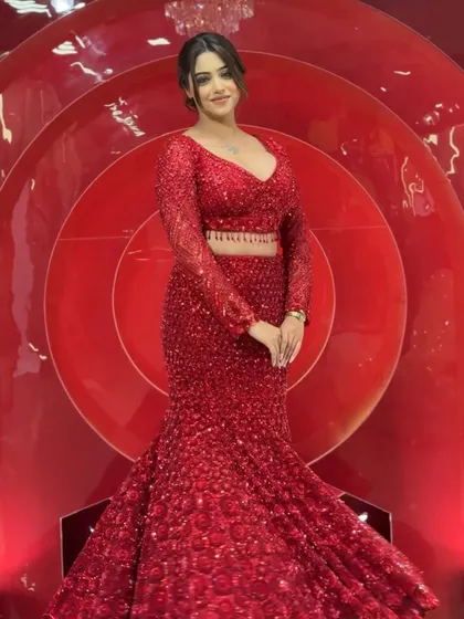 This all-red sequin fish-cut gown is a complete showstopper and one of our most requested pieces. It’s designed to hug your curves and make a statement at any reception or cocktail party. The intricate sequin work catches the light beautifully, ensuring all eyes are on you.