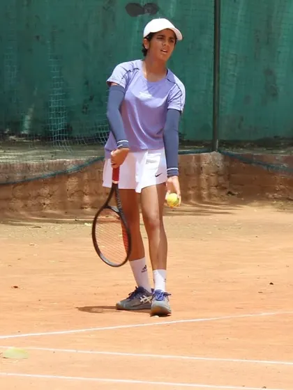 A player focused and ready to serve during a semifinal match. The serve is the most important shot, and we dedicate significant time to it.