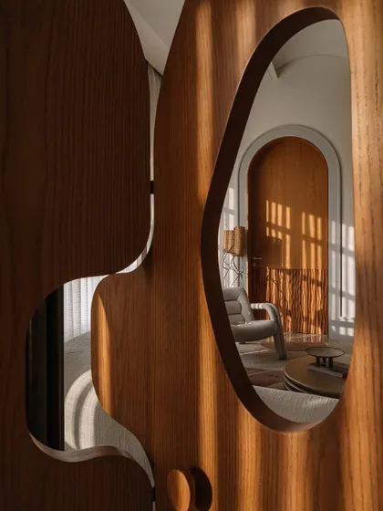 A close-up of the Hide N Seek screen, showing how the amoebic cutouts frame views of the room, playing with light and perspective.