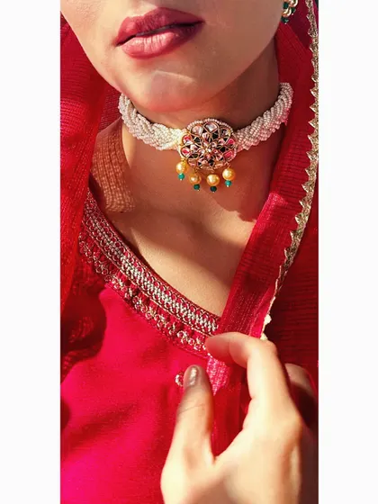 A close-up of a delicate, handcrafted kundan and pearl choker. This type of piece is perfect for a Mehendi or Sangeet, adding a touch of royalty without being overpowering.