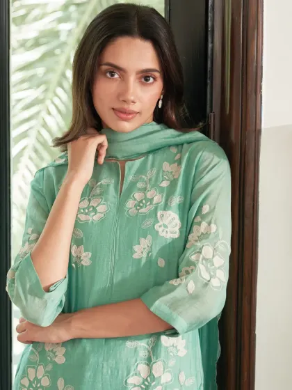 When the day calls for comfort, but you still want to look like you tried. This mint green suit with white floral embroidery feels just right for a casual festive gathering.