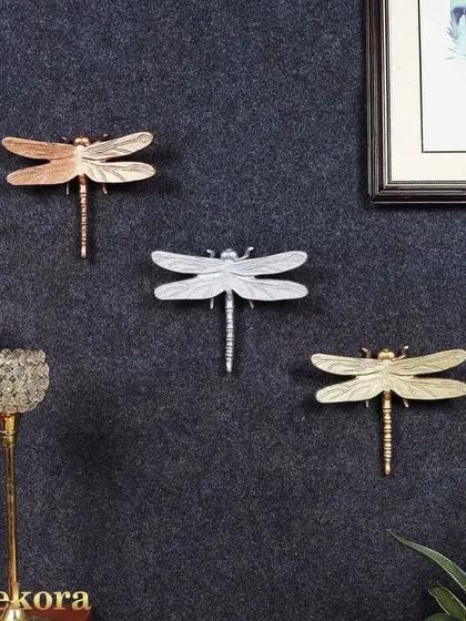 A set of three dragonfly wall hooks in gold, silver, and rose gold finishes. These are a charming and functional way to add a touch of nature to your decor.