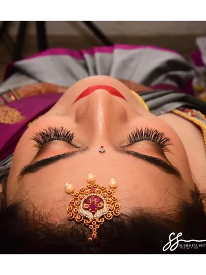 With eyes closed, you can fully appreciate the delicate shimmer on the eyelids and the length of the lashes. This is a key part of creating a dreamy, romantic bridal look.