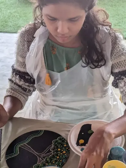A participant working on a dot mandala with a tree of life design, combining two beautiful and symbolic art forms.