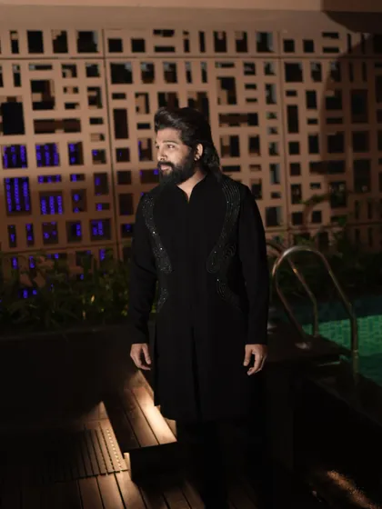 Allu Arjun at the 'Pushpa 2' trailer launch in a custom Amit Aggarwal piece. The structured, embellished details on the shoulders add a futuristic edge to the classic black kurta.