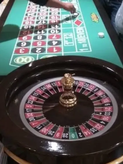 Bring the excitement of Las Vegas to your party with our casino game rentals. This professional roulette table setup, complete with chips, is perfect for a 40th birthday bash, corporate event, or a themed casino night.