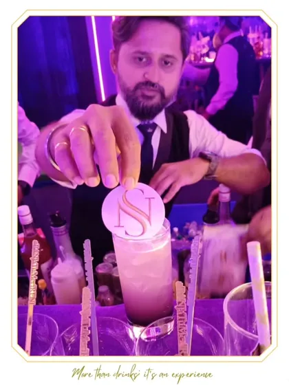 A personalized cocktail featuring the couple's initial "S" on top. Our mixologist is adding the final touches to this bespoke creation.