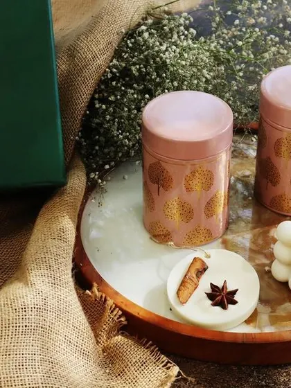 My 'Diwali Illumination Box', a curated hamper featuring a bubble candle, a cinnamon wardrobe freshener, and tins of almonds and raisins.