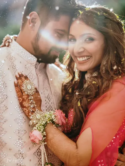 A sun-drenched, happy close-up of a couple during their Haldi ceremony, capturing a moment of pure bliss.