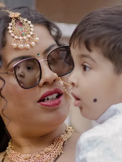 A sweet, candid moment between a wedding guest and a child, showcasing the family atmosphere.