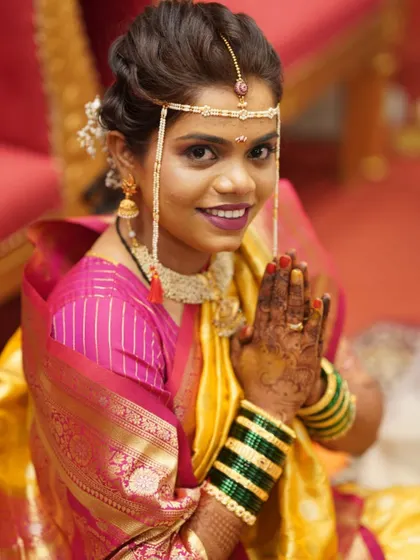 A welcoming namaste from the bride before her Haldi ceremony begins. Her makeup is subtle yet radiant.