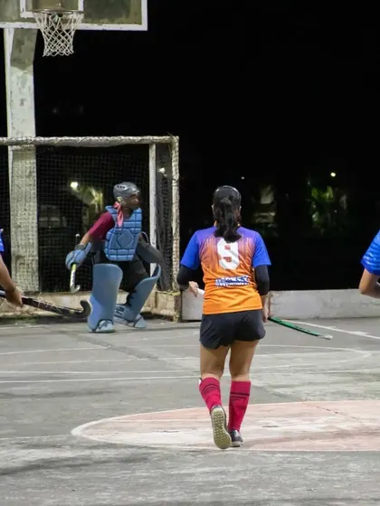 Our girls' team in action during an exhibition match at the BARC Inter-Department Rink Hockey Event. This night game was a great opportunity to showcase their skills.