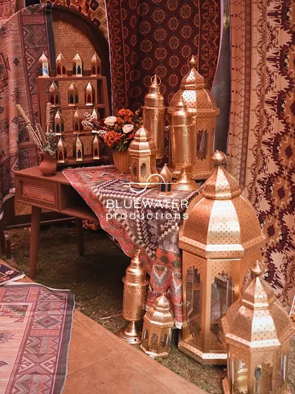 A detail shot from the 'Souk' entrance, with stacks of brass lanterns and patterned textiles.