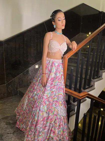 A gorgeous printed lehenga with a pearl-fringed blouse, perfect for a day wedding or Mehendi. The turquoise jewellery adds a beautiful pop of color.