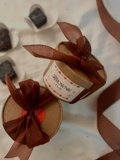 Introducing our fudgy brownie tubs. Each tub contains bite-sized pieces of our eggless brownies drenched in a rich chocolate sauce for an irresistible dessert experience.