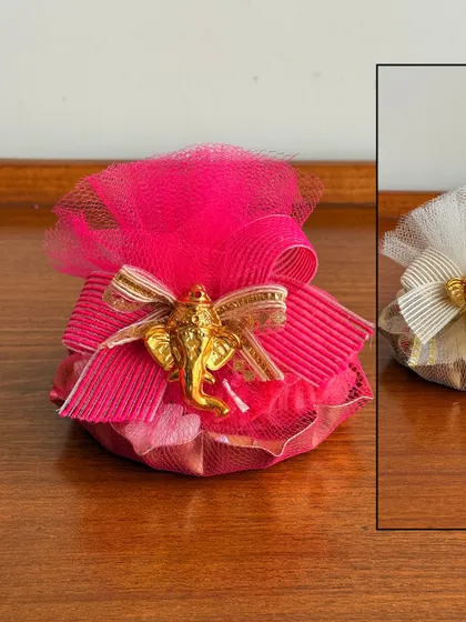 Another version of our festive potli gift, this one in a vibrant pink. These small, thoughtful gifts are ideal for bulk orders and party favors.