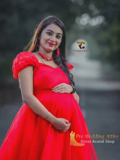 A close-up portrait in the red ruffled gown, showing the delicate puff sleeves and rich color. This rental dress is designed to be beautiful from every angle, ensuring stunning close-up and full-body shots.