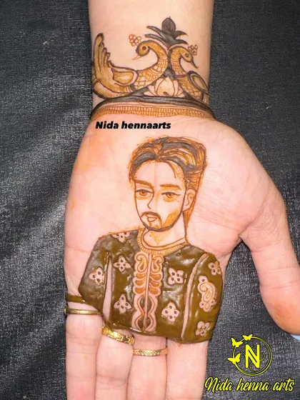 A close-up of a realistic groom portrait on the palm. I pay close attention to details like the style of the turban and the groom's expression.