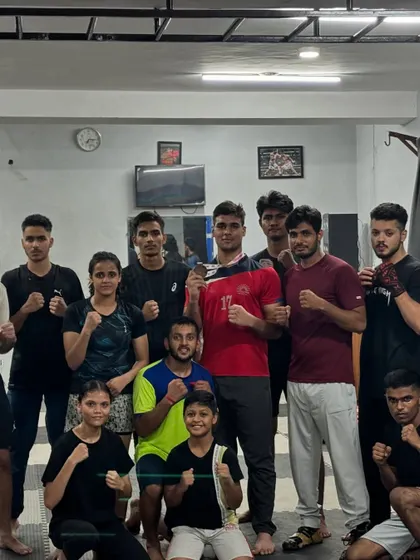 The whole team posing with Vaibhav after his bronze medal win. We celebrate each other's victories as a family.