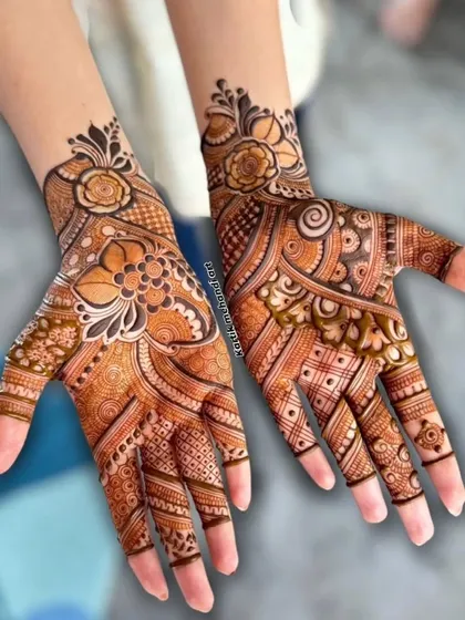 A beautiful floral mehandi design, perfect for an engagement or pre-wedding function. The mix of bold flowers and delicate patterns creates a stunning look.