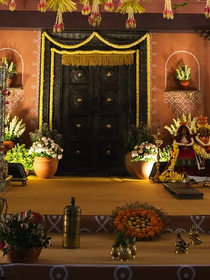 A closer look at the intricate details of the naming ceremony stage. We included elements like Kondapalli toys, brass vessels, and a vintage gramophone to perfectly capture the 1990s village aesthetic.