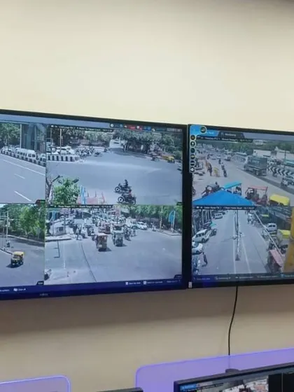 Two large wall-mounted monitors showing multiple camera angles of a busy street. This kind of setup is ideal for businesses or security offices that need to watch over a large area.