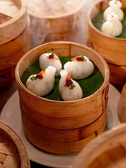 Steaming dim sum in traditional bamboo baskets. We use techniques like capturing steam to add a sense of freshness and authenticity to our food photography.
