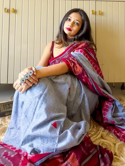 A relaxed, seated pose in the Ikat saree. The cotton fabric is breathable and comfortable, making it a great choice for a long day.