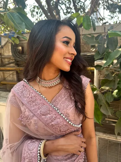 A happy and glowing client ready for her event. The makeup is subtle yet defining, focusing on luminous skin and bright eyes.
