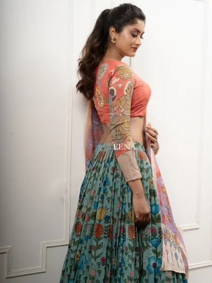 Discover the beauty of traditional craftsmanship with this stunning Pen Kalamkari lehenga. The piece is meticulously hand-painted by my artisans, with a story unfolding on the blouse sleeves and a beautiful floral pattern on the skirt and dupatta.