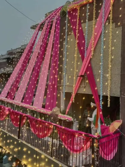 See how a home exterior comes alive at night. I use thousands of fairy lights woven into the drapes to create a magical, glittering effect that makes your celebration visible and special, even from a distance.