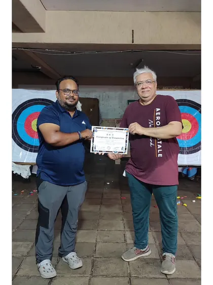 A smile of accomplishment. This student is officially a certified beginner archer.
