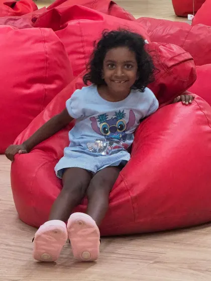 My daughter Kaadu, my most honest critic and biggest fan, enjoying the setup before a storytelling session. Seeing the world through a child's eyes helps me keep my sessions imaginative and joyful.