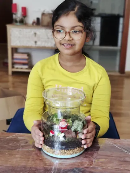 Another happy participant from our closed terrarium workshop. The Santa figurine adds a fun, festive touch to her creation.