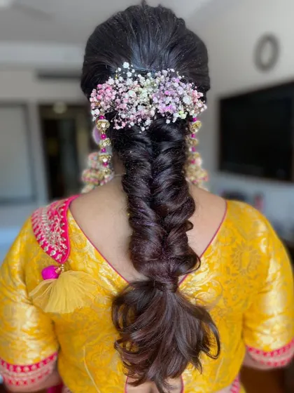 Another view of the messy fishtail braid, showing its texture and the beautiful floral arrangement.