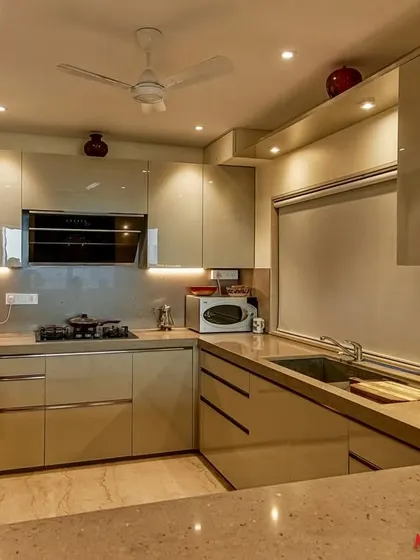 A wide shot of the C-shaped acrylic kitchen, highlighting its spacious layout and modern aesthetic.