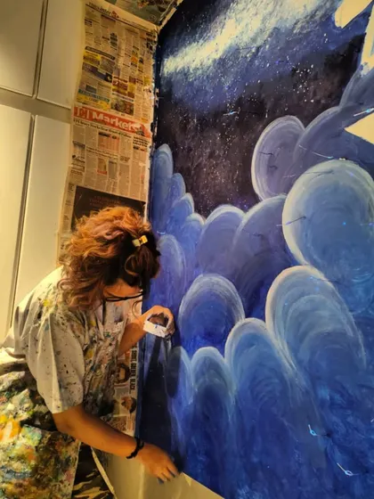 A close-up of me peeling off the masking tape, one of the most satisfying parts of the process. The deep blues of the night sky are really coming together here.