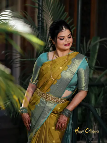 A beautiful portrait of the bride, her smile lighting up the frame as she stands among lush greenery.
