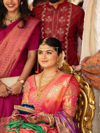 The bride seated during the ceremony, looking calm and beautiful. The makeup is set to last for hours of sitting and celebrating.