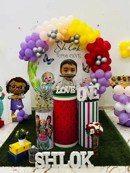 We created this fun Cocomelon world for Wafa Abbas's first birthday, featuring the iconic yellow school bus and a rainbow of balloons.