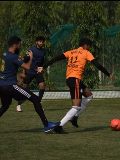 Anirudh showcasing his dribbling skills against a defender. I train my players to be confident and effective in attacking situations.