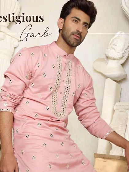 Prestigious Garb. This striking pink kurta with delicate mirror work is designed to let you own the moment with confidence and style.