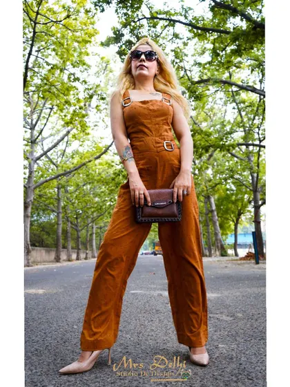 A chic and edgy look in a custom brown corduroy jumpsuit. This is a versatile piece that can be dressed up or down for any occasion.