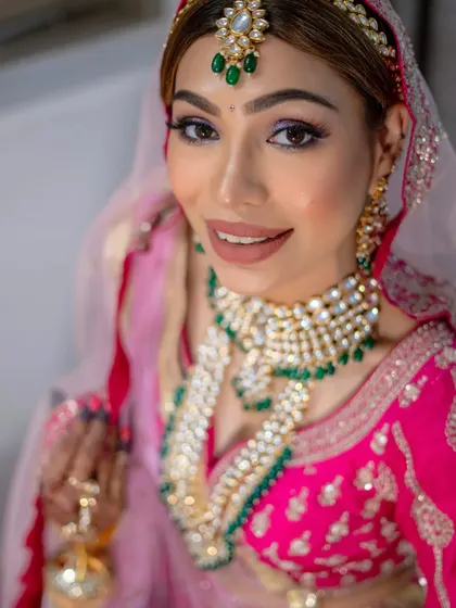 My best friend's wedding. For Priyanka, we did my signature holographic eyes paired with a fresh, radiant glow that looked stunning with her pink and green ensemble.