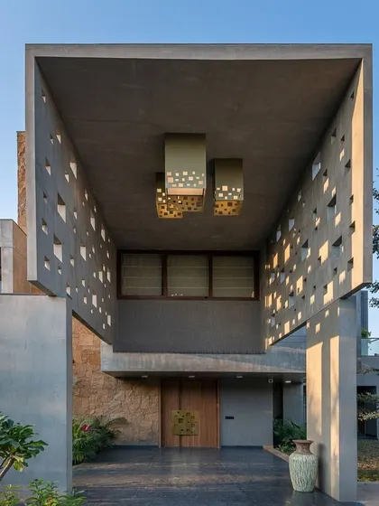 The entrance to your home sets the tone for everything else. For this project, I designed a commanding entryway with perforated concrete walls that create beautiful light patterns, offering a glimpse of the architectural detail within.