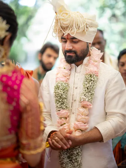 A candid shot of the groom during the ceremony. His focused and gentle expression shows the depth of emotion and sincerity involved in the wedding rituals.