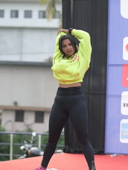Taking a moment to stretch on stage before a big event. Proper warm-ups and flexibility are key to preventing injury and ensuring peak performance.