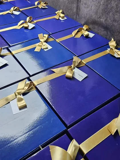 Here are the finished hampers for BMS Institute, all beautifully wrapped in royal blue boxes with elegant gold ribbons. We ensure that the final presentation is as impressive as the gifts inside.