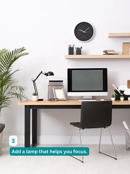 Good lighting is key for focus. This minimalist home office setup includes a sleek desk lamp and floating shelves, creating a bright and organized workspace.