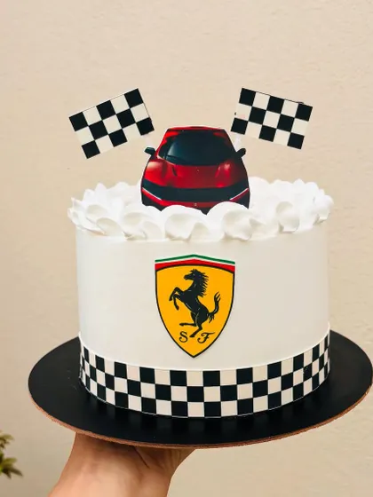 For the Ferrari fan, this cake features the iconic logo, a checkered flag border, and a red sports car topper.
